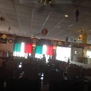a view of a dining room with tables and chairs