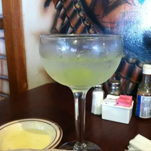 a glass of margarita on a table