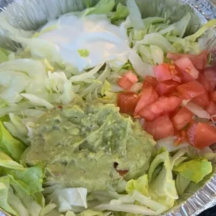 Salad, guac, tomatoes, and sour cream