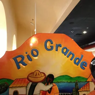 a man sitting in front of a sign