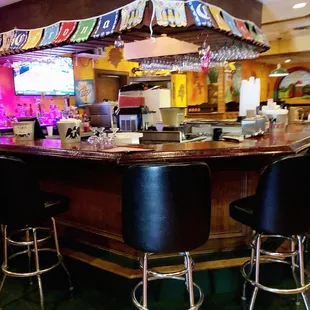 a bar with black chairs
