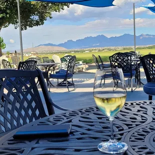 a glass of wine on a patio table
