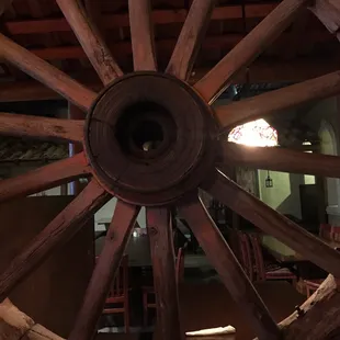 Cool old wagon wheel between bar and dining area
