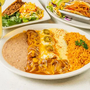 a plate of mexican food and a glass of orange juice