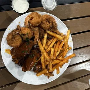 this is their fried shrimp and wing platter. the sauce on the wings was spicy garlic. i also ordered grilled oysters