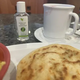 a plate of food and a cup of coffee