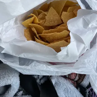 a person holding a bag of tortillas