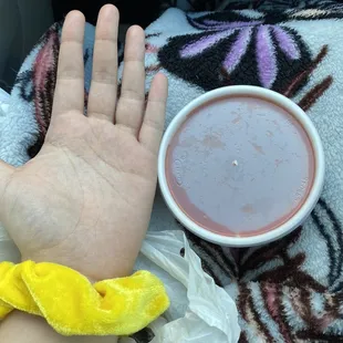 a person's hand and a cup of hot chocolate