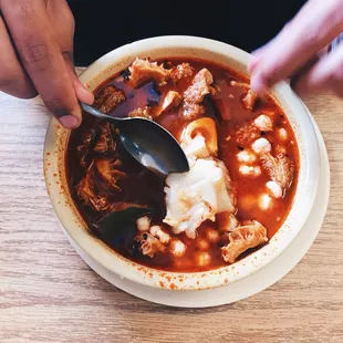 a person eating a bowl of soup