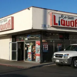 a truck parked in front of a liquor store