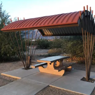 Several shaded picnic benches