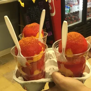 two cups of ice cream with strawberries and strawberries
