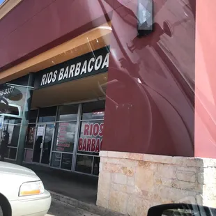 a car parked in front of a restaurant