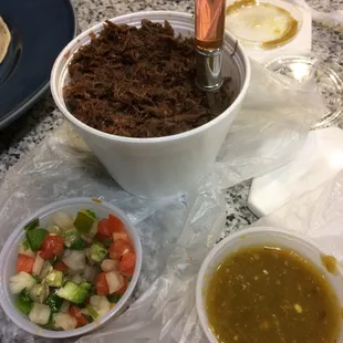 1 lb. barbacoa, 10 corn tortillas, and small container of salsa verde for $12.99. Small container of Pico de Gallo for $1.35.