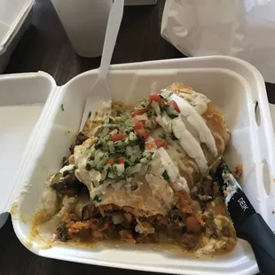 an enchilada in a styrofoam container