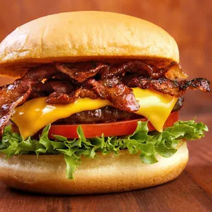 a bacon cheeseburger with lettuce and tomato