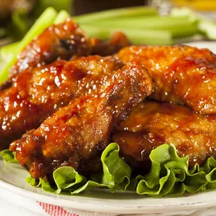 a plate of chicken wings and lettuce
