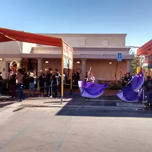 a group of people standing on the street