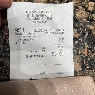 a person holding a receipt in their hand