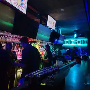 people at a bar with neon lights