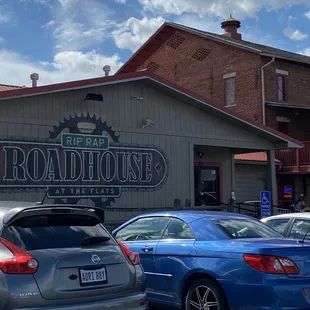 cars parked in front of a restaurant