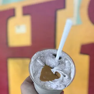 a hand holding a drink