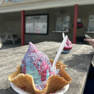 Cotton Candy Sundae with blueberry soft serve and cotton candy hard shell in a fresh waffle bowl
