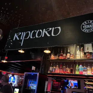 a man standing in front of a bar