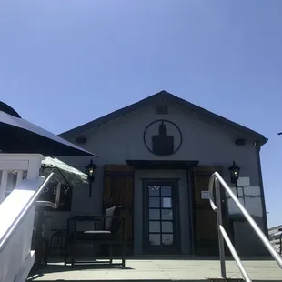 the front of a house with umbrellas
