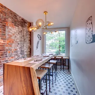 a brick wall and wood table