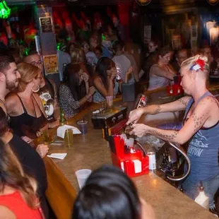 a woman pouring a drink at a bar