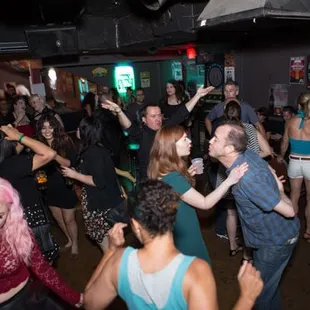 a group of people dancing in a club