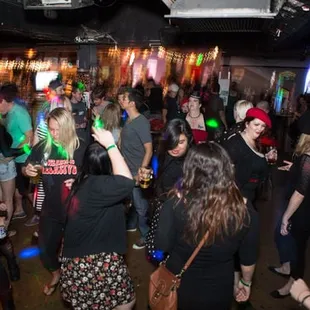 a crowd of people dancing at a party