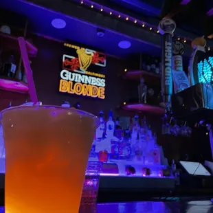 a glass of beer on a bar