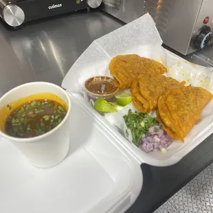 Quesabirrias with a side of consomé to dip them in.