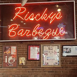 a neon sign above a bar
