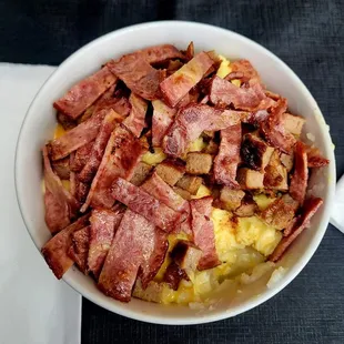 Grit Bowl comes with grits, eggs, your choice of meat and cheese.