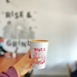 a person holding a cup of coffee