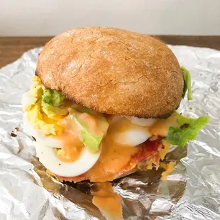 Breakfast Bunwich Sandwich: Hard boiled egg with fresh avocado, cheese, bacon and aioli, served between a fresh bun. #DustinEatsSF