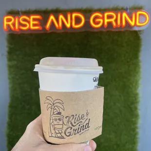 a hand holding a cup of coffee