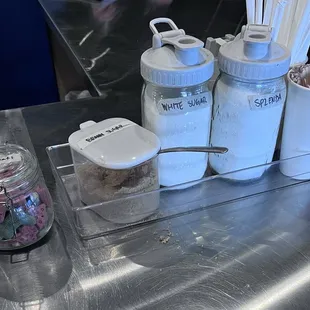 Dog treats, sugar options, stirrers, straws and napkins up front