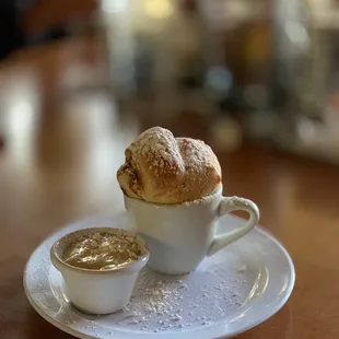 a cup of soup and a pastry