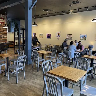 people sitting at tables in a restaurant