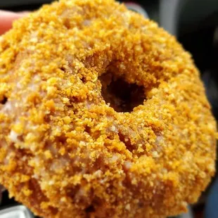 a hand holding a donut