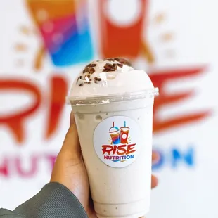 a hand holding a cup of ice cream