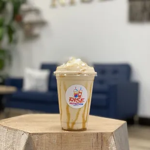 a cup of iced coffee on a wooden table