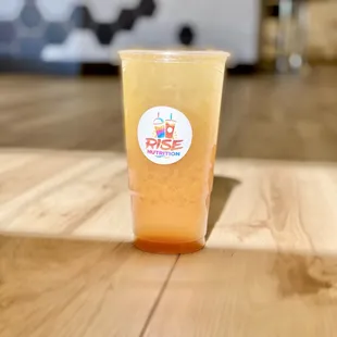 a cup of juice on a wooden table