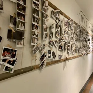 a long hallway with many pictures on the wall