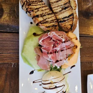 Burrata with melon, prosciutto, and yummy bread