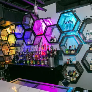 a bar with hexagons on the wall